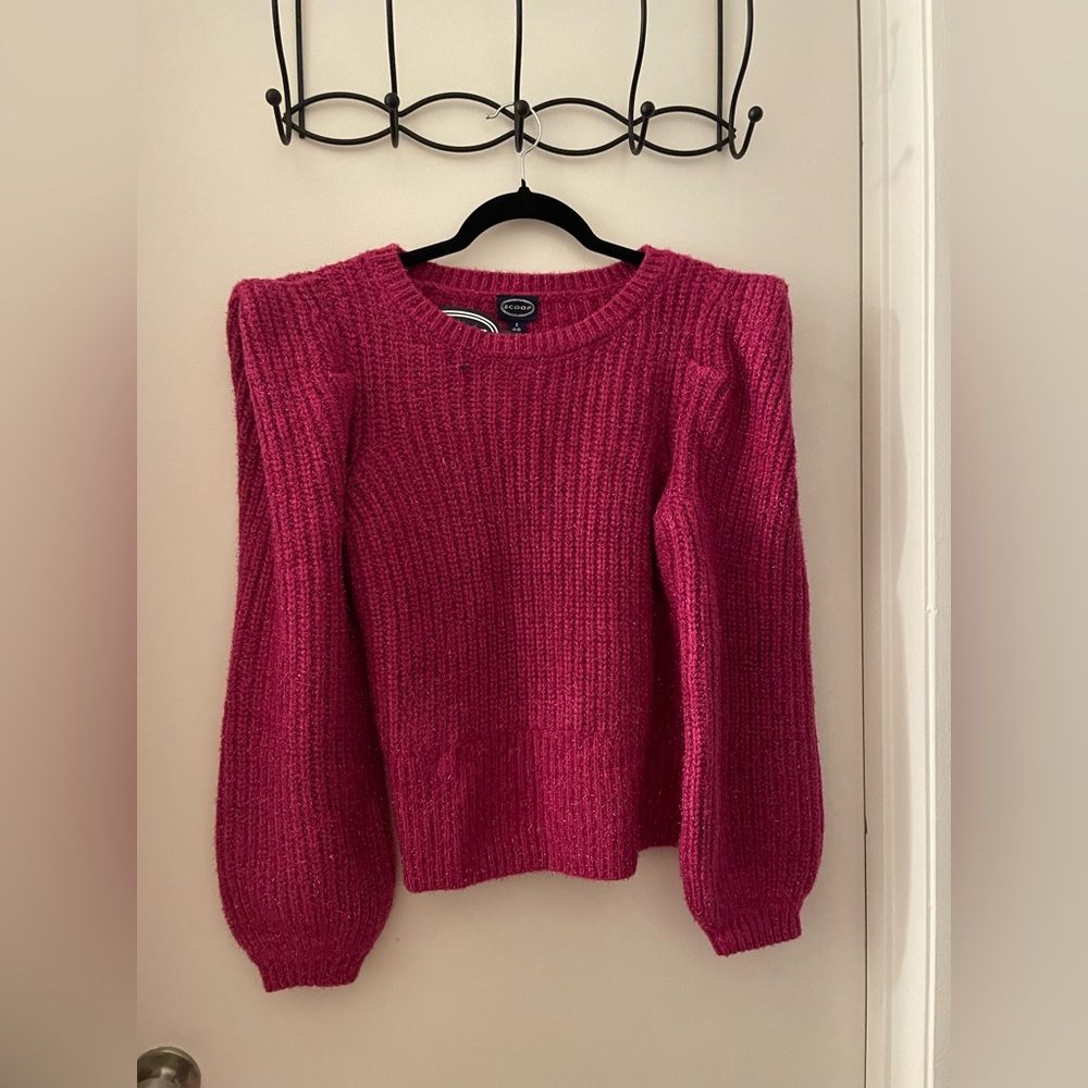 Hot pink sweater with puffy shoulders.